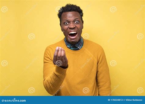 african man  angry showing italian gesture  yellow