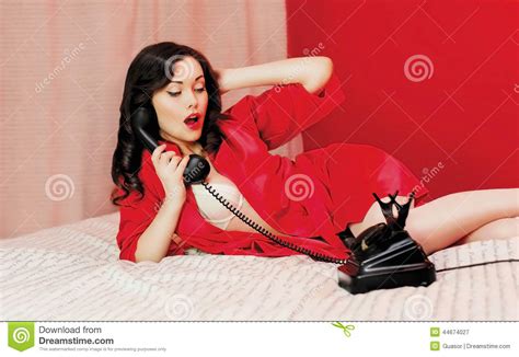 Beautiful Sexy Woman Lying On The Bed With Telephone Stock