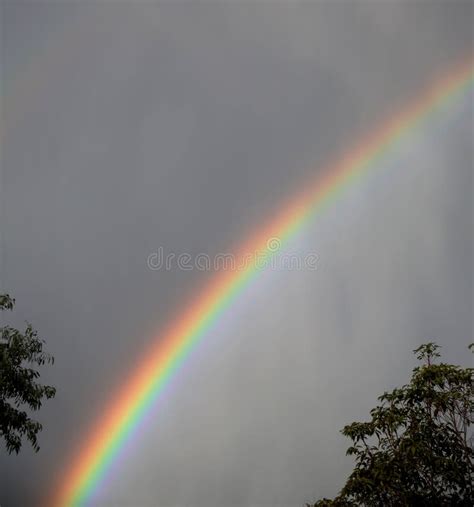 rainbow  grey clouds stock photo image   dramatic
