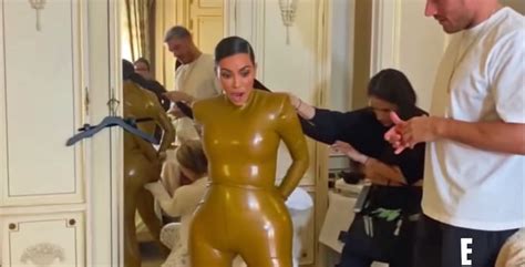 watch kim kardashian squeeze into her latex balmain outfit popsugar fashion