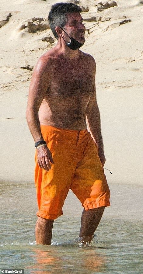 shirtless simon cowell sports a facemask as he joins