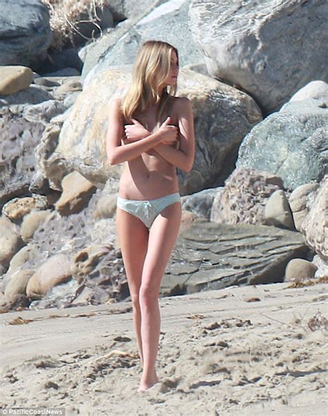 stella maxwell throws off her shirt as she goes topless for beach photoshoot daily mail online