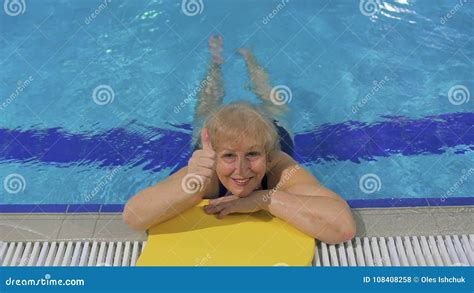 Pretty Granny Shows Thumb Up Swimming In The Pool Stock Footage Video