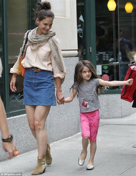 katie holmes tries out a new style as she dotes on daughter suri in new