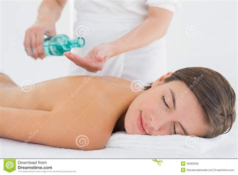 Attractive Woman Getting Massage Oil On Her Back Stock