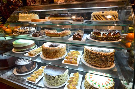 symposium cafe milton cake display showcasing   delicious desserts    locations
