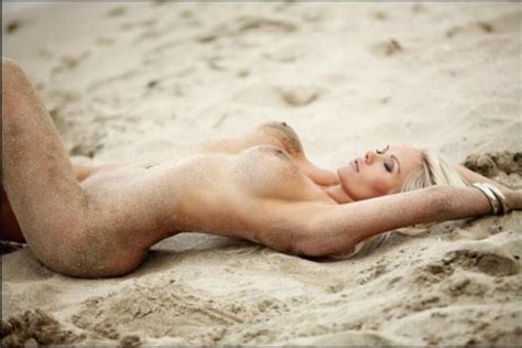 girls covered in sand