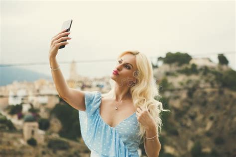 graceful blonde woman in her 40s taking selfies stock image image of