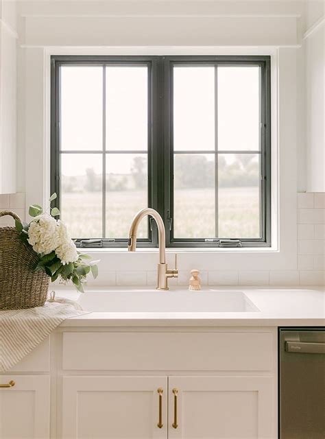 black casement windows  sink command attention  white kitchen pella
