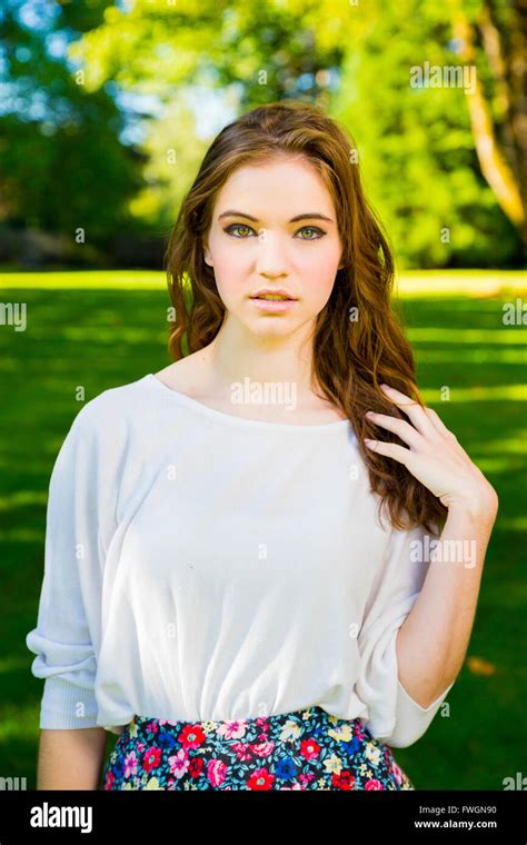 A Beautiful Young Girl Poses For A Fashion Style Portrait Outdoors At A