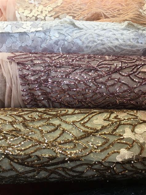 fancy embroidered sequin lace on mesh fabric sold by the