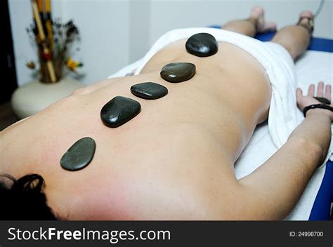 Man Relaxing On Massage Bed With Hot Stones Free Stock