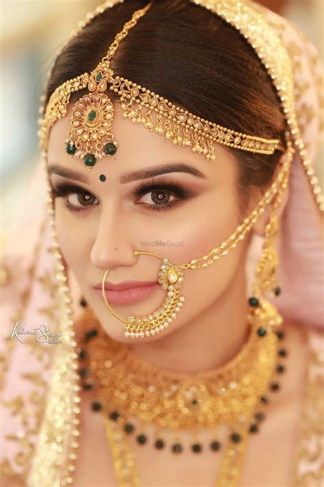 photo of a beautiful bride on her wedding day in stunning gold jewellery