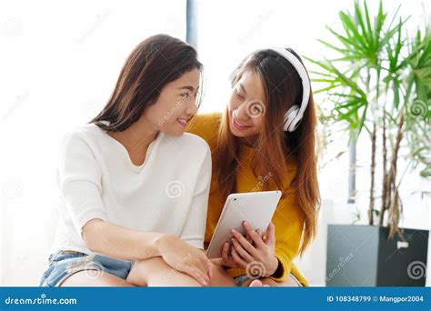 Young Cute Asia Lesbian Couple Using Tablet With Happiness Lgbt Stock