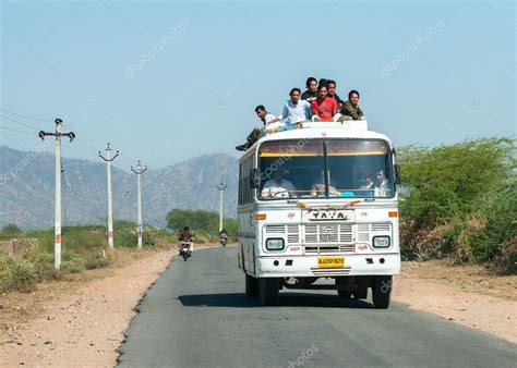 rajasthan  india february  public transport bus  plenty  passengers   roof
