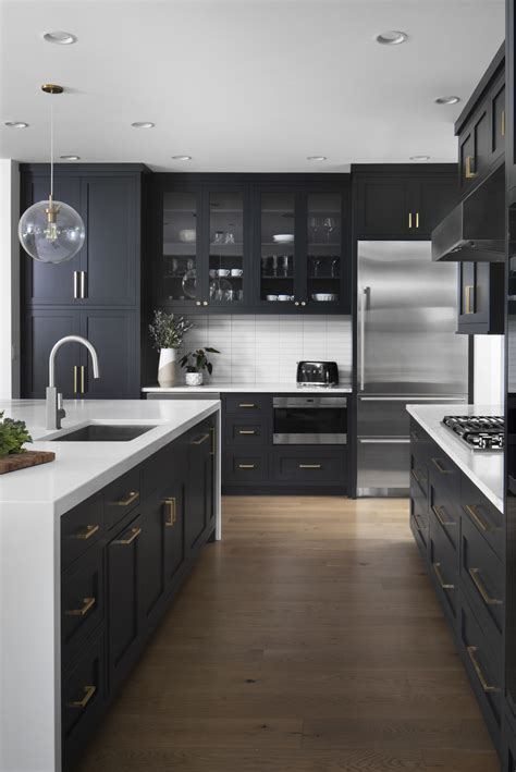 modern kitchen white countertop dark cabinet brushed gold accents stainless steel lakeside