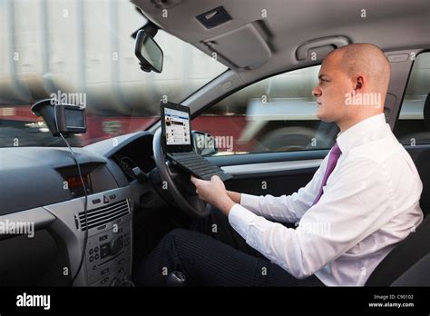 man  laptop computer  driving car  motorway stock photo