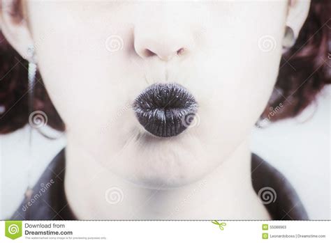 closeup photo of a beautiful black lips giving kiss stock