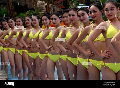 Chinese Bikini Dressed Models Pose In Line In The Water At Sanya