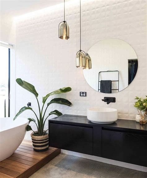 a gorgeous luxe black and white bathroom with pops of gold