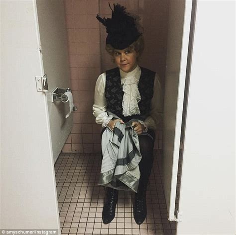 amy schumer is snapped sitting on a toilet in victorian garb for