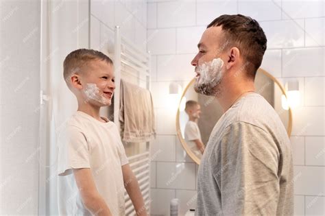 Premium Photo Dad Teaching His Son How To Shave