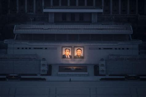 picture of a person passing portraits of north korean