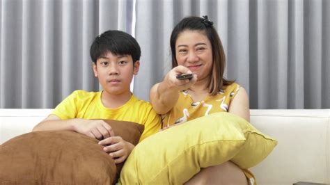 watching tv lying on couch asian mom son stock footage sbv 330143423