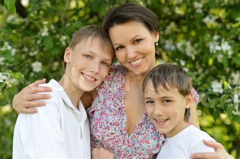happy mom with her two sons rest on the stock image