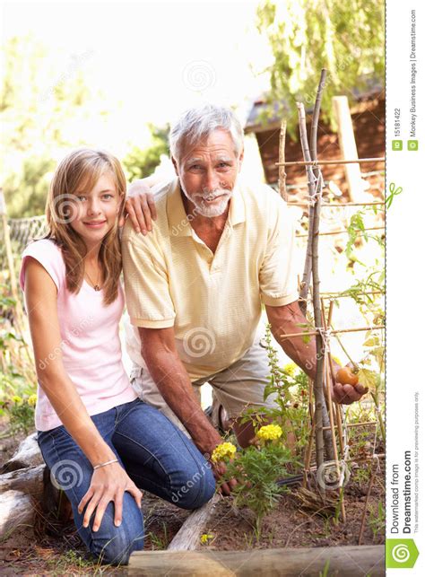 teenage granddaughter and grandfather relaxing in stock