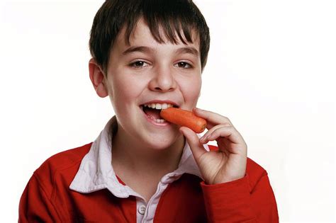 boy eating  carrot photograph  mauro fermarielloscience photo