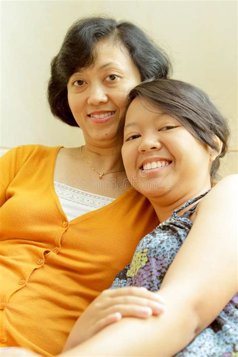 asian mother happy talking with teen daughter stock image