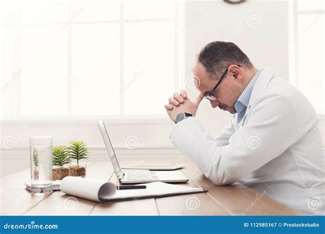 Tired Doctor Isitting At Workplace In Hospital Stock Image Image Of