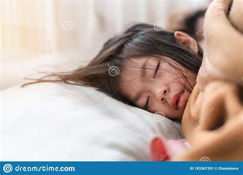 Young Asian Girl Sleeping On White Pillow On Bed In Bedroom In Morning