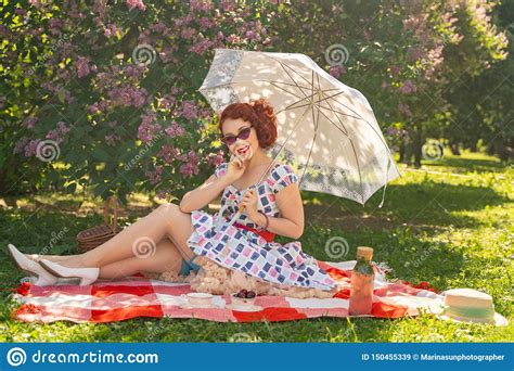 red haired happy pin up girl in vintage summer dress and