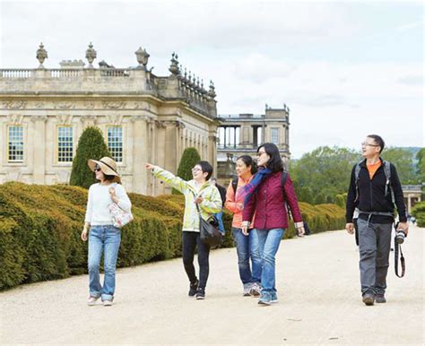chinese visitors tour the grounds of chatsworth house in derbyshire the stately home and seat of
