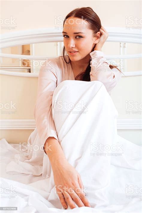 Young Pretty Brunette Woman Laying In Bed Luxury White Interior Stock