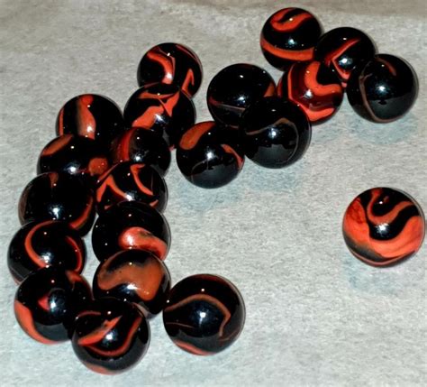 black and orange vintage toy marbles i think these are two