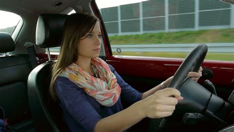 irresponsible young girl driving  car  talking   cell phone stock footage video