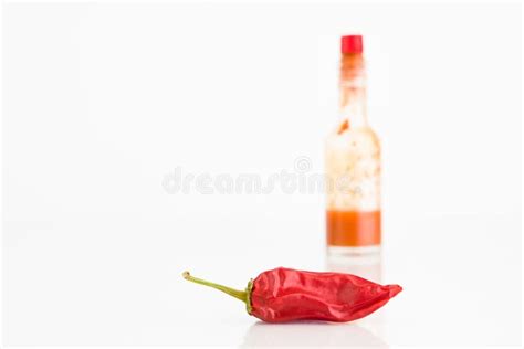 Roodgloeiend Chili Pepper And Bottle Of Chili Sauce Stock Afbeelding