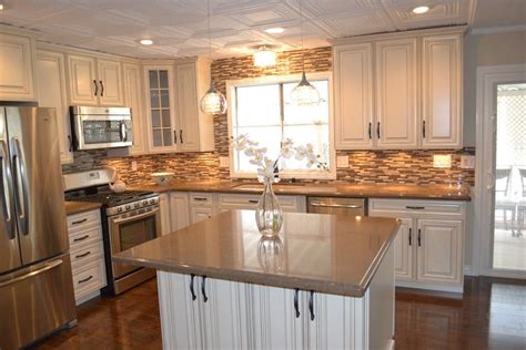 large kitchen  white cabinets  stainless steel appliances including  island