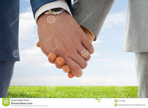 Close Up Of Male Gay Hands With Wedding Rings On Stock