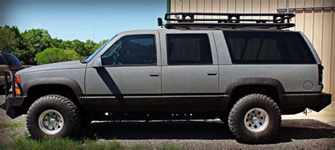 suv parked  front   building   metal roof rack   flatbed