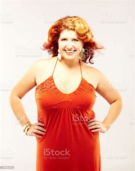 Beautiful Voluptuous Redhead Fashion Model In Red Dress Smiling Stock