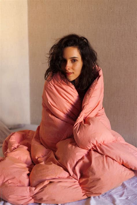Portrait Of A Brunette In Her Bed Covered By Pink Sheet Del