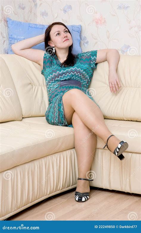 woman sitting   sofa stock photo image  dress