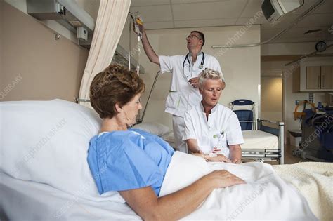 nurses preparing a patient for an iv line stock image
