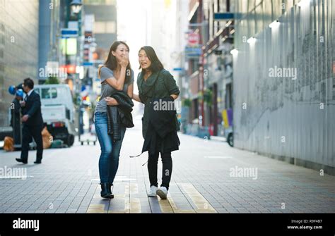 Two Girlfriends Meeting Outdoors And Having Fun Japanese People