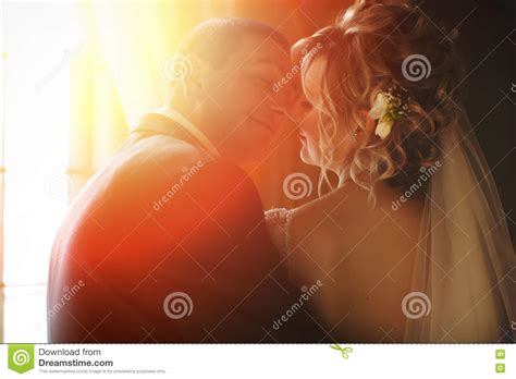 a view from behind on a wedding couple kissing in the