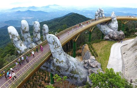 vietnams  spectacular  bridge  held aloft   pair  hands